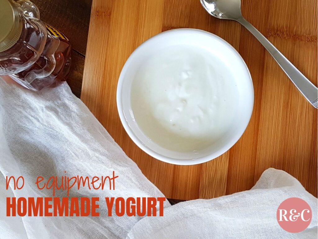 Yogurt in a white dish on a background of wood, with honey and a spoon seen in the background; with text: no equipment homemade yogurt.