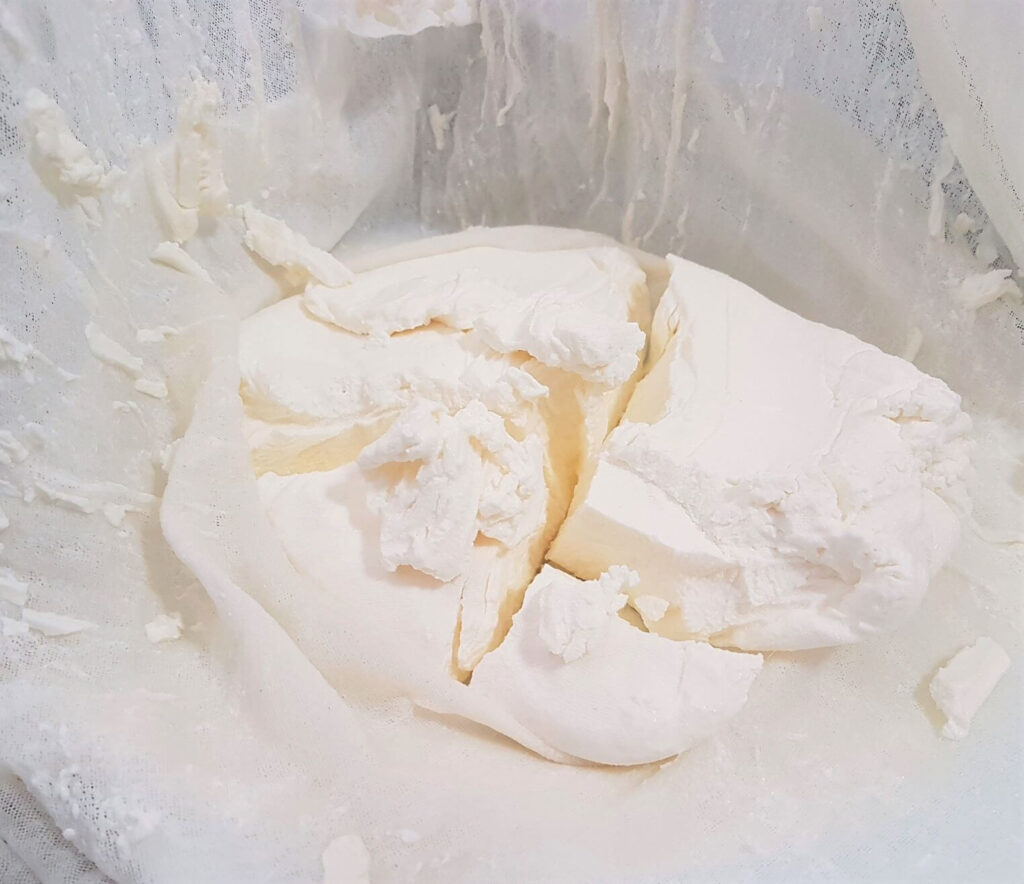 A block of freshly made Labneh (yogurt cheese) on cheesecloth.